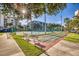 Community shuffleboard court and tennis court surrounded by lush landscaping at 5300 S Atlantic Ave # 12-401, New Smyrna Beach, FL 32169