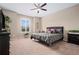 Comfortable bedroom with plush carpet, neutral walls, and a ceiling fan at 5648 Nw 40Th Loop, Ocala, FL 34482