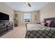 Inviting bedroom with plush carpet, neutral walls, a ceiling fan, and plenty of natural light at 5648 Nw 40Th Loop, Ocala, FL 34482