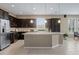 Stylish kitchen featuring an island, dark cabinetry, and stainless steel appliances at 5648 Nw 40Th Loop, Ocala, FL 34482