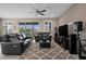 Comfortable living area featuring plush seating, a sliding glass door, and entertainment center at 5648 Nw 40Th Loop, Ocala, FL 34482