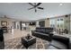 Open-concept living room with a spacious layout, ceiling fan, and access to dining and kitchen at 5648 Nw 40Th Loop, Ocala, FL 34482