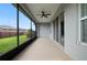 Covered screened patio with ceiling fan and views of green lawn and fence at 5648 Nw 40Th Loop, Ocala, FL 34482