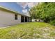 Spacious backyard featuring a covered patio and mature landscaping at 565 Morgan Wood Dr, Deland, FL 32724