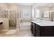 Elegant bathroom with a luxurious soaking tub, enclosed glass shower, and dark wood vanity cabinet at 565 Morgan Wood Dr, Deland, FL 32724