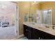 Clean bathroom with a double vanity, a large mirror, and an adjacent open doorway to another room at 565 Morgan Wood Dr, Deland, FL 32724