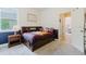 Warm and inviting bedroom featuring a baseball themed bed, and an open doorway to another room at 565 Morgan Wood Dr, Deland, FL 32724