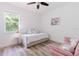 Cozy bedroom with a daybed, a pink couch, and natural light, creating a welcoming, bright space at 565 Morgan Wood Dr, Deland, FL 32724