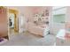 Bright, pink bedroom with carpeted floor at 565 Morgan Wood Dr, Deland, FL 32724