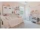 Charming bedroom featuring stylish decor, custom shelving, and soft natural light at 565 Morgan Wood Dr, Deland, FL 32724