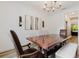 Bright dining room features wood floors, neutral walls, a wooden table and modern art at 565 Morgan Wood Dr, Deland, FL 32724