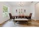 Elegant dining room with a wooden table, chandelier, and lots of natural light at 565 Morgan Wood Dr, Deland, FL 32724