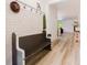 Stylish entryway features planked walls, coat hooks, a charming bench, and beautiful wood flooring at 565 Morgan Wood Dr, Deland, FL 32724