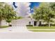 Inviting single-story home with manicured lawn, tidy landscaping, and a spacious two-car driveway at 565 Morgan Wood Dr, Deland, FL 32724