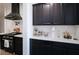 Kitchen featuring white countertops, dark cabinets, and modern appliances at 565 Morgan Wood Dr, Deland, FL 32724