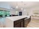 Bright kitchen featuring a large island with quartz countertop and modern pendant lighting at 565 Morgan Wood Dr, Deland, FL 32724