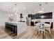 Spacious kitchen with dark cabinets, large island, and dining area at 565 Morgan Wood Dr, Deland, FL 32724