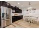 Spacious kitchen with stainless steel refrigerator, dark cabinets, and a dining area at 565 Morgan Wood Dr, Deland, FL 32724