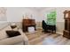 Bright living room featuring wood floors, neutral paint, a piano, sofa, and a sunlit window at 565 Morgan Wood Dr, Deland, FL 32724