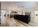 Spacious living room with wood floors adjacent to open kitchen and dining area at 565 Morgan Wood Dr, Deland, FL 32724