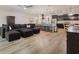 Spacious living room with wood floors adjacent to open kitchen and dining area at 565 Morgan Wood Dr, Deland, FL 32724