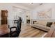 Bright view of the office with wood floors, a sofa, piano, desk and connected to the dining room at 565 Morgan Wood Dr, Deland, FL 32724