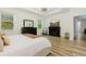 Main bedroom with tray ceilings, hardwood floors, and plenty of natural light at 565 Morgan Wood Dr, Deland, FL 32724