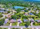 Panoramic aerial view of a community featuring mature trees, a serene lake, and a variety of homes, showcasing a picturesque neighborhood at 5936 Boggs Ford Rd, Port Orange, FL 32127