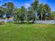 Spacious backyard with lush green grass, mature trees, and a well-maintained fence, providing a serene and private outdoor space at 5936 Boggs Ford Rd, Port Orange, FL 32127