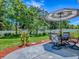 Charming patio area with outdoor dining set and umbrella, surrounded by lush greenery, perfect for entertaining and relaxation at 5936 Boggs Ford Rd, Port Orange, FL 32127
