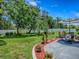 Expansive backyard oasis with lush lawn, mature trees, and a patio seating area for outdoor enjoyment, relaxation, and al fresco dining at 5936 Boggs Ford Rd, Port Orange, FL 32127
