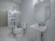 Bathroom with a pedestal sink, tiled floors, and a large mirror reflecting a spacious interior at 5936 Boggs Ford Rd, Port Orange, FL 32127