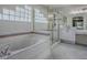 This bathroom features a glass-enclosed shower and tub with white tiling and a block glass window for natural lighting at 5936 Boggs Ford Rd, Port Orange, FL 32127