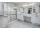 The bathroom features a glass-enclosed shower and white vanities, tiled floors, and neutral accents throughout at 5936 Boggs Ford Rd, Port Orange, FL 32127