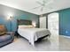 This primary bedroom features a decorative headboard, neutral accents, and an ensuite bathroom with a walk-in shower at 5936 Boggs Ford Rd, Port Orange, FL 32127