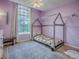 This charming ' bedroom is lit with a large window and features colorful decor and a playful atmosphere at 5936 Boggs Ford Rd, Port Orange, FL 32127