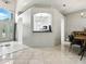 Open-concept living space flows into a dining area with a view of the kitchen, creating an inviting and modern atmosphere at 5936 Boggs Ford Rd, Port Orange, FL 32127