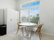 Bright dining area featuring a table with seating, a built-in cabinet, and a large window for natural light at 5936 Boggs Ford Rd, Port Orange, FL 32127