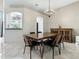 Formal dining room with modern chandelier, a cabinet and access to the kitchen at 5936 Boggs Ford Rd, Port Orange, FL 32127
