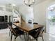 Modern dining room area with staircase access and natural lighting at 5936 Boggs Ford Rd, Port Orange, FL 32127