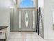 Bright foyer features a decorative front door with sidelights and tile flooring, creating an elegant entrance at 5936 Boggs Ford Rd, Port Orange, FL 32127