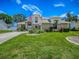 Inviting two-story home has a lush green lawn and landscaped garden beds, enhancing the curb appeal at 5936 Boggs Ford Rd, Port Orange, FL 32127