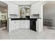 Well-lit kitchen with granite countertops, white cabinets, and stainless steel appliances at 5936 Boggs Ford Rd, Port Orange, FL 32127