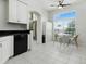 Bright kitchen features sleek black appliances, granite countertops, a dining area, and ample cabinet space for storage at 5936 Boggs Ford Rd, Port Orange, FL 32127