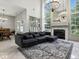 Bright living room boasts large windows, fireplace, and stylish chandelier at 5936 Boggs Ford Rd, Port Orange, FL 32127