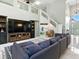 Inviting living room featuring a staircase and a large television at 5936 Boggs Ford Rd, Port Orange, FL 32127