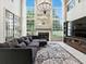Elegant living room with fireplace, large windows, and TV at 5936 Boggs Ford Rd, Port Orange, FL 32127
