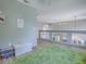 Bright loft area with light wood floors, a soft green rug and views of the dining area below at 5936 Boggs Ford Rd, Port Orange, FL 32127