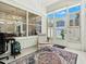Bright sunroom features tile floors, large windows, and a comfortable sitting area, perfect for relaxation and enjoying the natural light at 5936 Boggs Ford Rd, Port Orange, FL 32127