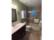 Bathroom featuring a tiled shower-tub combo and marble sink at 6211 Oak River Ter, Port Orange, FL 32127